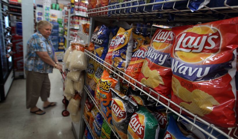 MIAMI -MARCH 22: A woman walks past bags of chips manufactured by PepsiCo Frito-Lay brand on a shelf on March 22, 2010 in Miami, Florida. PepsiCo announced plans to cut sugar, fat, and sodium in its products to address health and nutrition concerns. The maker of soft drinks including Pepsi-Cola, Gatorade also makes Frito-Lay brand snacks. (Photo by Joe Raedle/Getty Images)