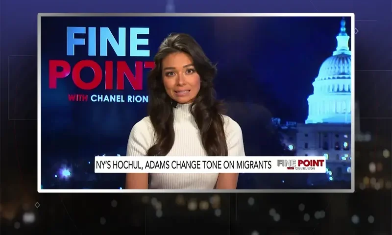 Video still of the host of Fine Point at the desk of their talk show on One America News Network.