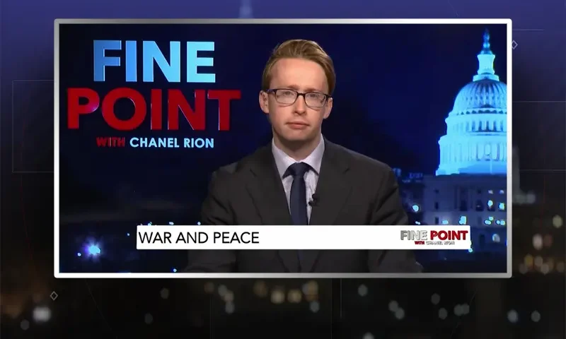 Video still of the host of Fine Point at the desk of their talk show on One America News Network.