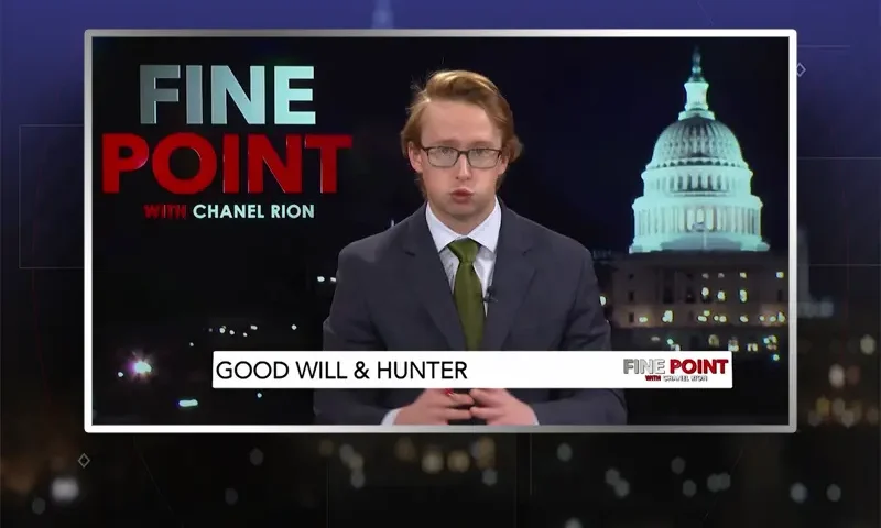 Video still of the host of Fine Point at the desk of their talk show on One America News Network.