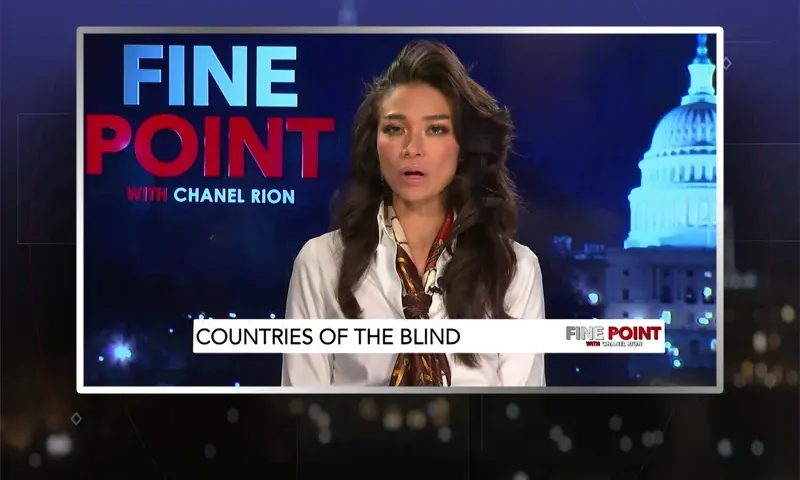 Video still of the host of Fine Point at the desk of their talk show on One America News Network.