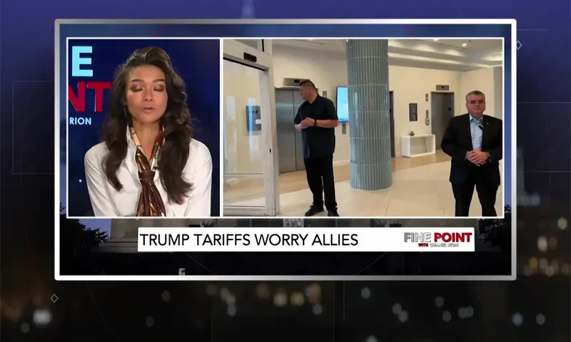 Video still of the host of Fine Point at the desk of their talk show on One America News Network.