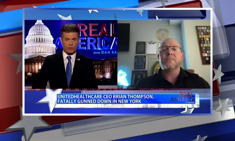 Video still from Real America on One America News Network showing a split screen of the host on the left side, and on the right side is the guest, Martin Green.