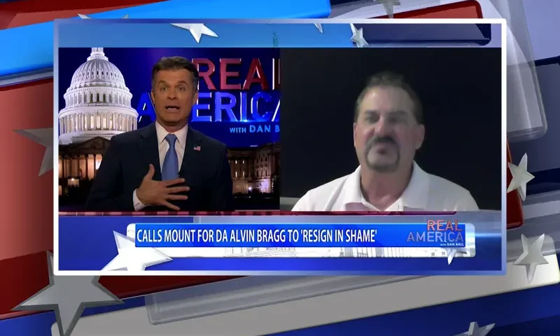 Video still from Real America on One America News Network showing a split screen of the host on the left side, and on the right side is the guest, David Wohl.