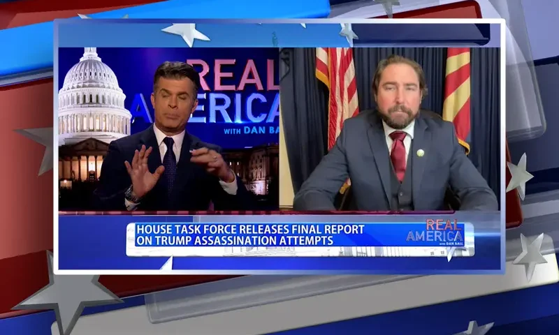 Video still from Real America on One America News Network showing a split screen of the host on the left side, and on the right side is the guest, Rep. Eli Crane.