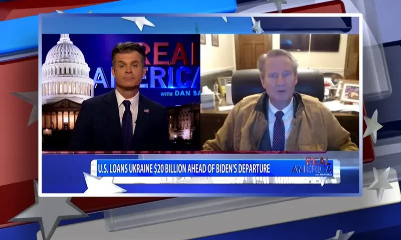 Video still from Real America on One America News Network showing a split screen of the host on the left side, and on the right side is the guest, Rep. Tim Burchett.