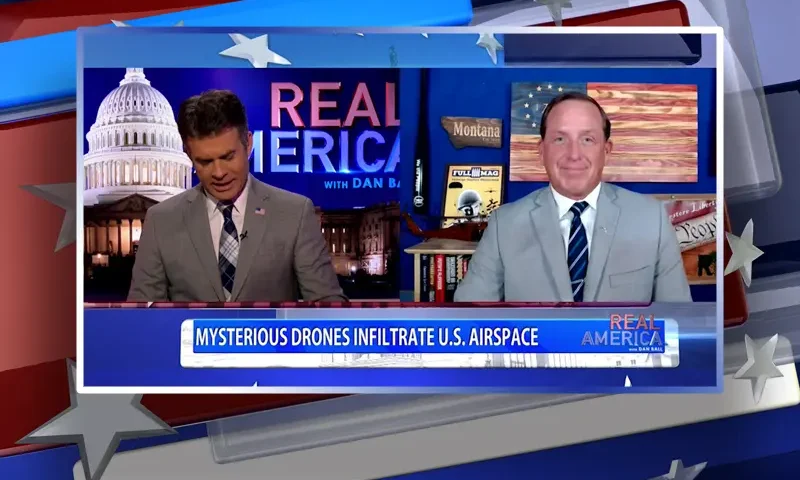 Video still from Real America on One America News Network showing a split screen of the host on the left side, and on the right side is the guest, Darin Gaub.