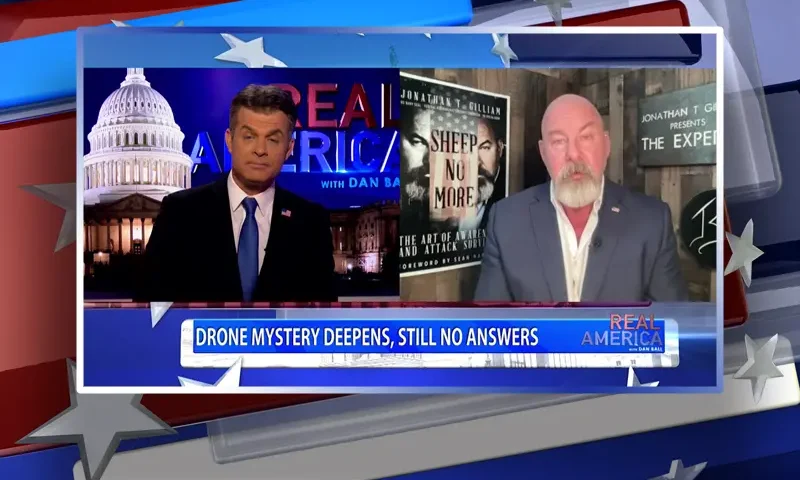 Video still from Real America on One America News Network showing a split screen of the host on the left side, and on the right side is the guest, Jonathan Gilliam.