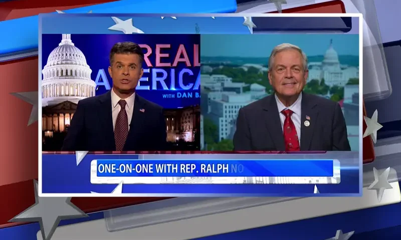 Video still from Real America on One America News Network showing a split screen of the host on the left side, and on the right side is the guest, Rep. Ralph Norman.