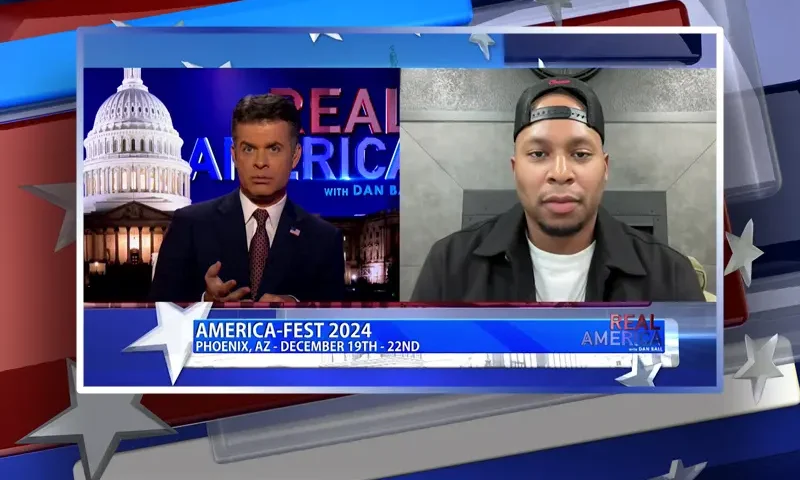 Video still from Real America on One America News Network showing a split screen of the host on the left side, and on the right side is the guest, Anthony Watson.