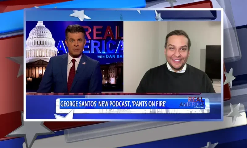 Video still from Real America on One America News Network showing a split screen of the host on the left side, and on the right side is the guest, George Santos.