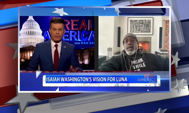 Video still from Real America on One America News Network showing a split screen of the host on the left side, and on the right side is the guest, Isaiah Washington.