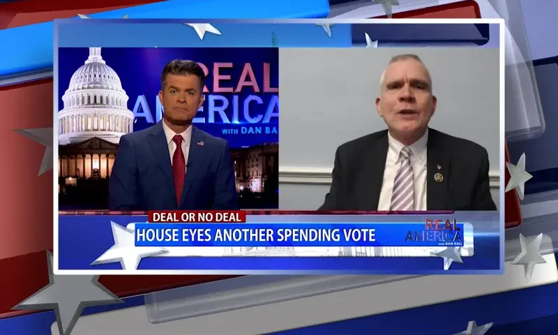 Video still from Real America on One America News Network showing a split screen of the host on the left side, and on the right side is the guest, Rep. Matt Rosendale.