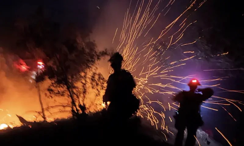 The wind whips embers while firefighters battle the fire in the Angeles National Forest near Mt. Wilson as the wildfires burn in the Los Angeles area, during the Eaton Fire in Altadena, California, U.S. January 9, 2025. REUTERS/Ringo Chiu