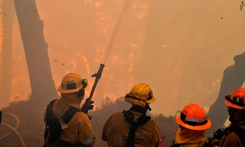 Firefighters work to protect a building at Mt. Wilson Observatory as the Bobcat Fire burns in the Angeles National Forest, northeast of Los Angeles, California on September 17, 2020. - The Bobcat Fire erupted on September 6 near the Cogswell Dam and West Fork Day Use area northeast of Mount Wilson within the Angeles National Forest, expanding from 46,263 acres to 50,539 acres since September 16 while remaining only 3% contained. (Photo by Frederic J. BROWN / AFP) (Photo by FREDERIC J. BROWN/AFP via Getty Images)