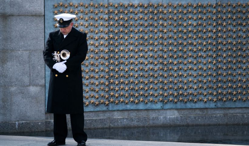 WASHINGTON, DC - DECEMBER 07: A trumpeter with a military honor guard pauses at the World War II Memorial during a wreath-laying ceremony to mark National Pearl Harbor Remembrance Day on December 7, 2020 in Washington, DC. On Dec. 7th, 1941, more than 2,400 Americans lost their lives in the surprise attack on a U.S. Naval station at Pearl Harbor by the Imperial Japanese Navy Air Service. The attack was the catalyst for the United States' entry into World War II. (Photo by Drew Angerer/Getty Images)