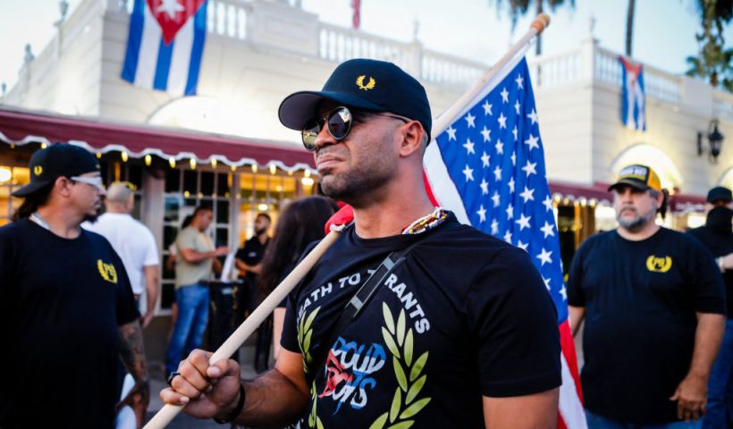 Henry "Enrique" Tarrio, leader of The Proud Boys, holds an US flags during a protest showing support for Cubans demonstrating against their government, in Miami, Florida on July 16, 2021. (Photo by Eva Marie UZCATEGUI / AFP) (Photo by EVA MARIE UZCATEGUI/AFP via Getty Images)