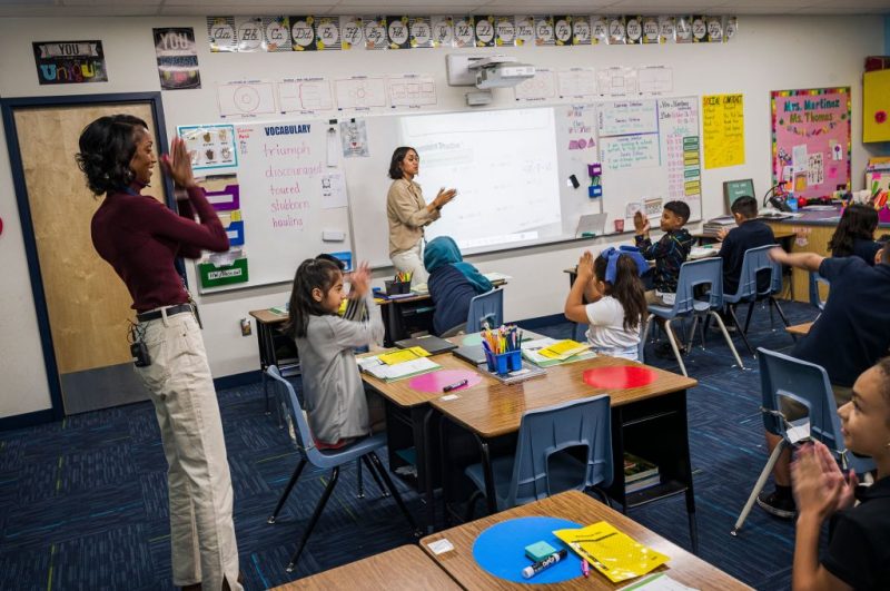 Aisha Thomas (L) is learns teaching skills with teacher Alexxa Martinez, in her classroom in Nevitt Elementary School, in Phoenix, Arizona, on October 26, 2022. - Teachers in Arizona are among the United States' lowest paid, making the cost-of-living crisis even more acute for educators in this key battleground for the upcoming mid-term elections. (Photo by Olivier TOURON / AFP) (Photo by OLIVIER TOURON/AFP via Getty Images)