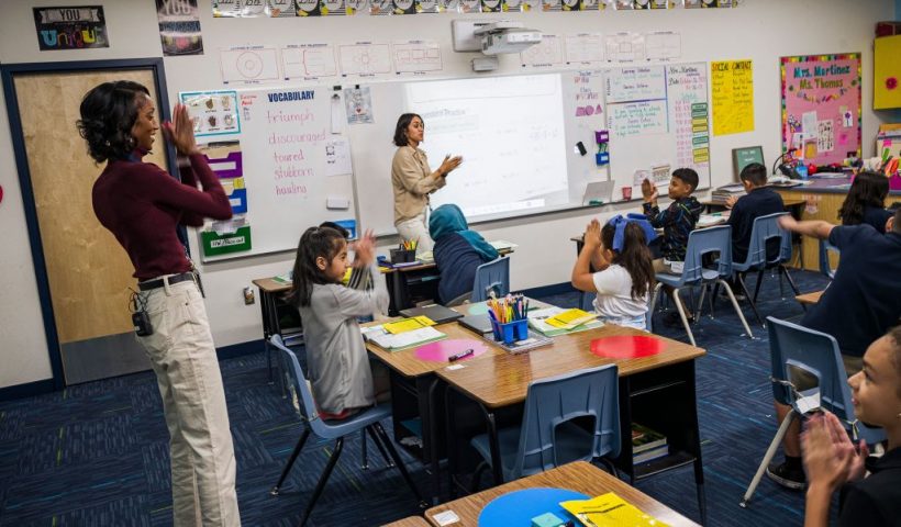 Aisha Thomas (L) is learns teaching skills with teacher Alexxa Martinez, in her classroom in Nevitt Elementary School, in Phoenix, Arizona, on October 26, 2022. - Teachers in Arizona are among the United States' lowest paid, making the cost-of-living crisis even more acute for educators in this key battleground for the upcoming mid-term elections. (Photo by Olivier TOURON / AFP) (Photo by OLIVIER TOURON/AFP via Getty Images)
