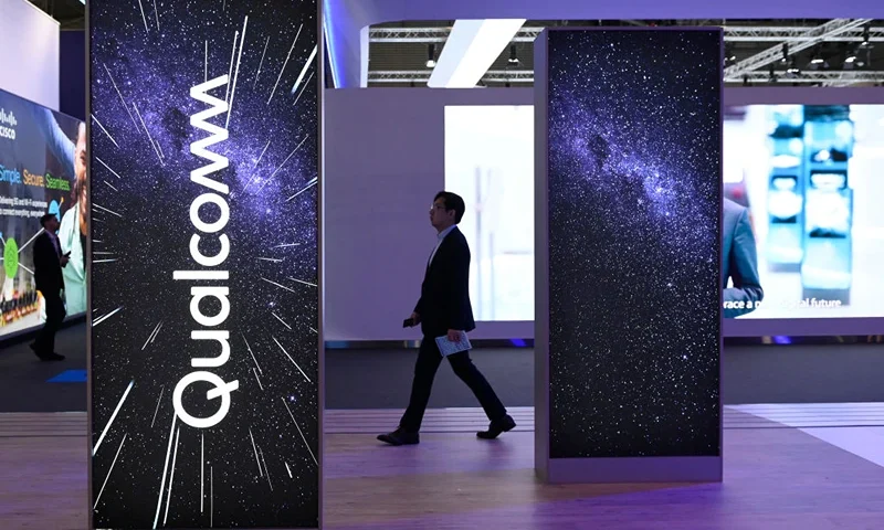 A visitor walks past the stand of American multinational corporation Qualcomm at the Mobile World Congress (MWC), the telecom industry's biggest annual gathering, in Barcelona on March 2, 2023. (Photo by Josep LAGO / AFP) (Photo by JOSEP LAGO/AFP via Getty Images)