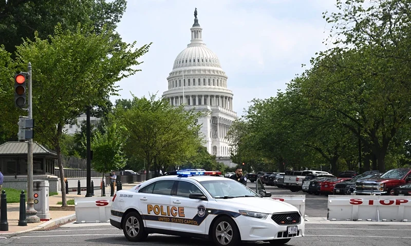 A US Capitol police officer stands by his car outside the Russell Senate Office Building in Washington, DC, on August 2, 2023, after unconfirmed eports of an active shooter in the building near the US Capitol. (Photo by SAUL LOEB / AFP) (Photo by SAUL LOEB/AFP via Getty Images)