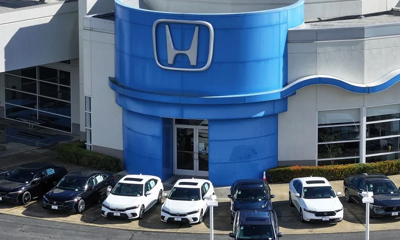 SAN RAFAEL, CALIFORNIA - FEBRUARY 06: In an aerial view, brand new Honda cars are displayed on the sales lot at Honda Marin on February 06, 2024 in San Rafael, California. Honda announced the recall of 750,000 vehicles in the U.S. for an air bag defect that could unintentionally deploy the air bags in a collision. The recall includes certain 2020 to 2022 Honda Pilot, Accord and Civic vehicles as well as 2020 and 2021 model years of Honda CR-V and Passport vehicles. (Photo by Justin Sullivan/Getty Images)