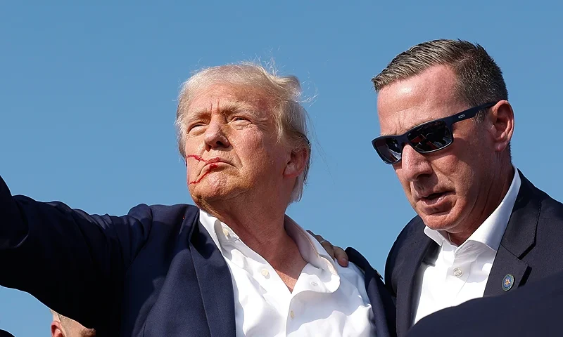 BUTLER, PENNSYLVANIA - JULY 13: Republican presidential candidate former President Donald Trump pumps his fist as he is rushed offstage during a rally on July 13, 2024 in Butler, Pennsylvania. Butler County district attorney Richard Goldinger said the shooter is dead after injuring former U.S. President Donald Trump, killing one audience member and injuring another in the shooting. (Photo by Anna Moneymaker/Getty Images)