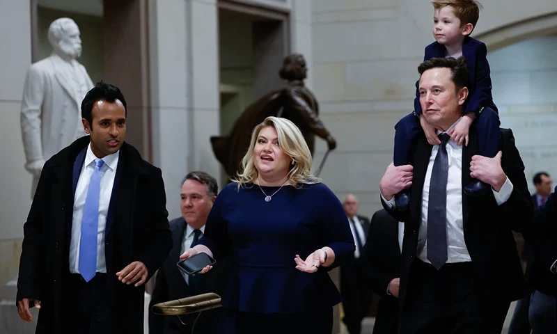 WASHINGTON, DC - DECEMBER 05: Tesla CEO Elon Musk (R), Co-Chair of the newly announced Department of Government Efficiency (DOGE) carries his son on his shoulders at the U.S. Capitol following a meeting with businessman Vivek Ramaswamy (L), Co-Chair of the newly announced Department of Government Efficiency, Rep. Kat Cammack (C), and other members of the U.S. Congress on December 05, 2024 in Washington, DC. Musk and Ramaswamy are meeting with members of the U.S. Congress today about DOGE, a planned presidential advisory commission with the goal of cutting government spending and increasing efficiency in the federal workforce. (Photo by Anna Moneymaker/Getty Images)