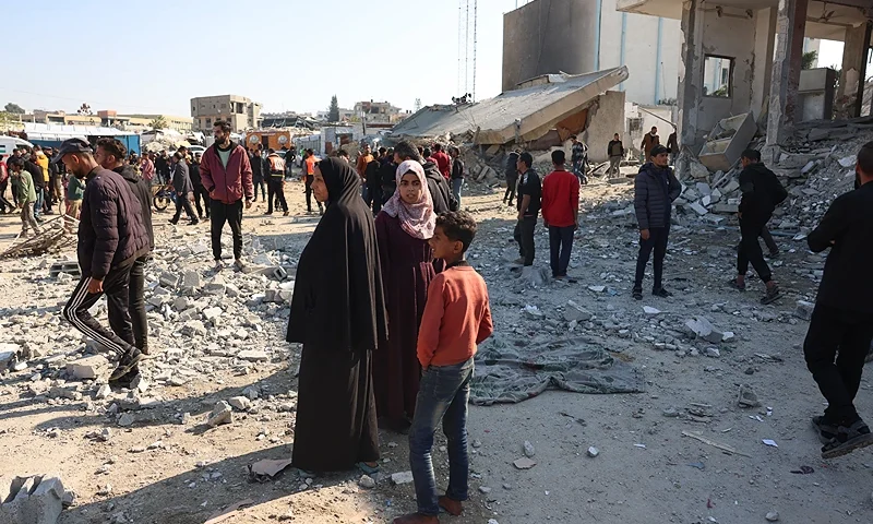 Palestinians check the damage following an Israeli strike that hit an administrative building in Khan Yunis in the southern Gaza Strip on January 2, 2025, amid the ongoing war between Israel and the Hamas movement. (Photo by BASHAR TALEB / AFP) (Photo by BASHAR TALEB/AFP via Getty Images)
