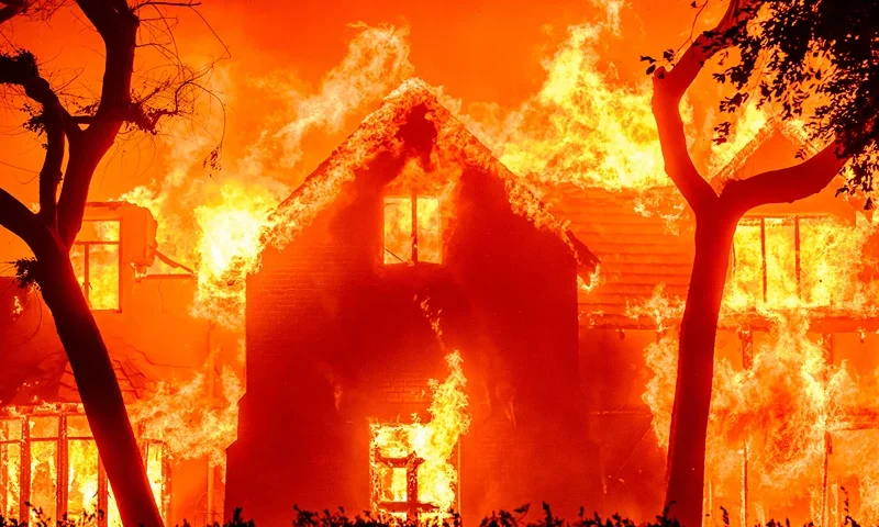 TOPSHOT - A home is engulfed in flames during the Eaton fire in the Altadena area of Los Angeles County, California on January 8, 2025. (Photo by JOSH EDELSON / AFP) (Photo by JOSH EDELSON/AFP via Getty Images)