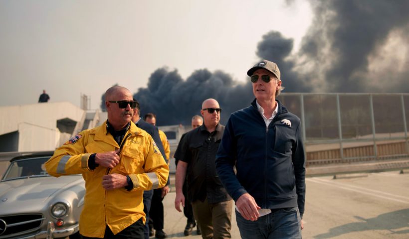 LOS ANGELES, CALIFORNIA - JANUARY 8: California Governor Gavin Newsom (R) tours the downtown business district of Pacific Palisades as the Palisades Fire continues to burn on January 8, 2025 in Los Angeles, California. Fueled by intense Santa Ana Winds, the Palisades Fire has grown to over 2,900 acres and 30,000 people have been ordered to evacuate while a second major fire continues to burn near Eaton Canyon in Altadena. (Photo by Eric Thayer/Getty Images)