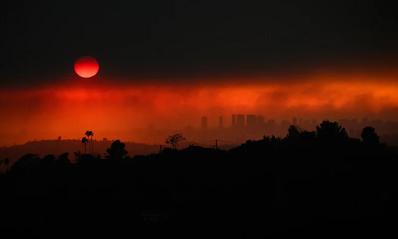 TOPSHOT - An aerial image shows smoke from wildfires including the Eaton Fire and Palisades Fire in Los Angeles, California, on January 8, 2025. At least five people have been killed in wildfires rampaging around Los Angeles, officials said on January 8, with firefighters overwhelmed by the speed and ferocity of multiple blazes. (Photo by Patrick T. Fallon / AFP) (Photo by PATRICK T. FALLON/AFP via Getty Images)