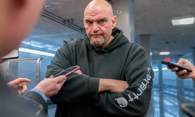 US Senator John Fetterman (D-PA) speaks to reporters as he goes to vote on the Laken Riley Act at the US Capitol in Washington, DC, on January 9, 2025. The Laken Riley Act -- which calls for the detention of undocumented immigrants charged with theft-related crimes -- is named for a 22-year-old student murdered by a Venezuelan man with no papers who was wanted for shoplifting. (Photo by Allison ROBBERT / AFP) (Photo by ALLISON ROBBERT/AFP via Getty Images)