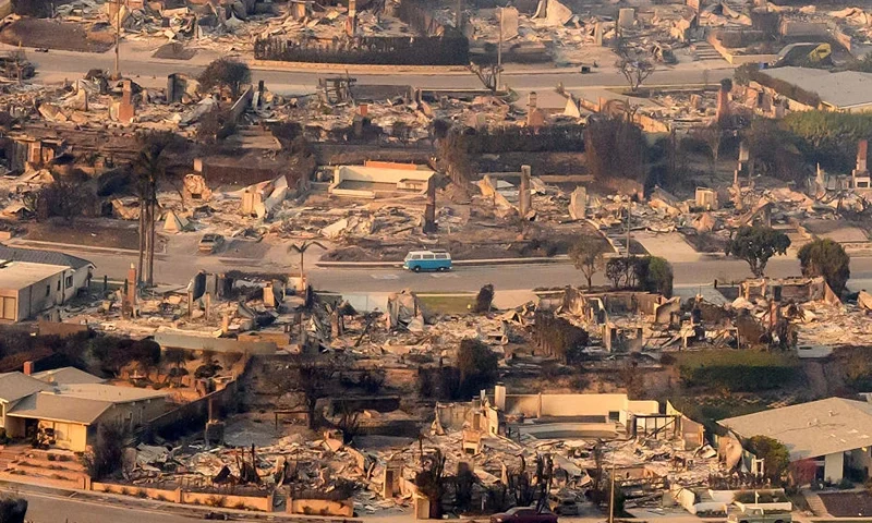 TOPSHOT - In this aerial view taken from a helicopter, burned homes are seen from above during the Palisades fire near the Pacific Palisades neighborhood of Los Angeles, California on January 9, 2025. Massive wildfires that engulfed whole neighborhoods and displaced thousands in Los Angeles remained totally uncontained January 9, 2025, authorities said, as US National Guard soldiers readied to hit the streets to help quell disorder. Swaths of the United States' second-largest city lay in ruins, with smoke blanketing the sky and an acrid smell pervading almost every building. (Photo by JOSH EDELSON / AFP) (Photo by JOSH EDELSON/AFP via Getty Images)