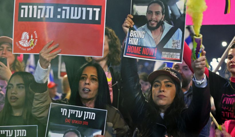 In this photograph taken on January 11, 2025, Ilana Gritzewsky (R), one of 105 Israeli hostages released during a one-week truce in November 2023, takes part in an anti-government protest calling for action to secure the release of Israelis held hostage since October 2023, in front of the Israeli defence ministry, in Tel Aviv. Gritzewsky was released from captivity more than a year ago, but with her partner and dozens of other Israeli hostages still held in Gaza, her fight is far from over. (Photo by Jack GUEZ / AFP) (Photo by JACK GUEZ/AFP via Getty Images)