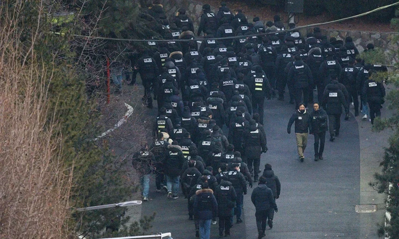 Police officers enter the compound of the presidential residence of impeached South Korea President Yoon Suk Yeol in Seoul on January 15, 2025. Impeached South Korean leader Yoon Suk Yeol was arrested on January 15 over his failed martial law bid, ending a weeks-long standoff with authorities and becoming the first sitting president to be detained in the nation's history. (Photo by ANTHONY WALLACE / AFP) (Photo by ANTHONY WALLACE/AFP via Getty Images)
