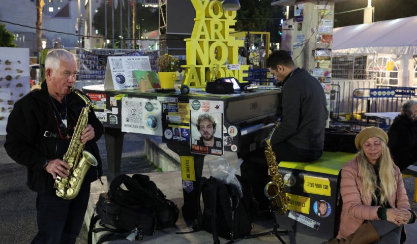 Musicians play in front of an installation set up on a square outside the Tel Aviv Museum of Art, now informally called the "Hostages Square", in Tel Aviv on January 16, 2025. Israel said on January 15 that several points in the Gaza ceasefire and hostage release deal still needed to be resolved but expected them to be finalised even as news spread that an agreement with Hamas had been reached. (Photo by Jack GUEZ / AFP) (Photo by JACK GUEZ/AFP via Getty Images)