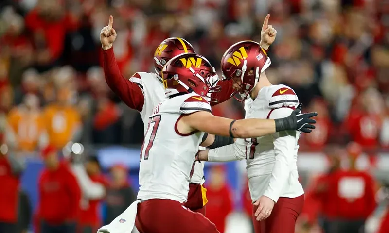 Zane Gonzalez #47 of the Washington Commanders celebrates with his teammates after making a 37 yard game winning field goal against the Tampa Bay Buccaneers to win the NFC Wild Card Playoff at Raymond James Stadium on January 12, 2025 in Tampa, Florida. (Photo by Mike Ehrmann/Getty Images)