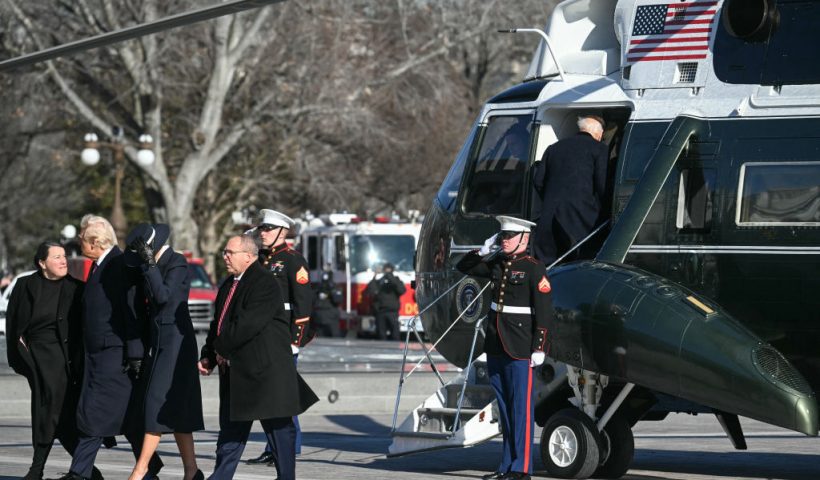 (L-R) US President Donald Trump and First Lady Melania Trump walk back toward the US Capitol after participating in a departure ceremony for former President Joe Biden and former First Lady Jill Biden, as the Bidens board a helicopter in Washington, DC, on January 20, 2025. (Photo by Jim WATSON / AFP) (Photo by JIM WATSON/AFP via Getty Images)