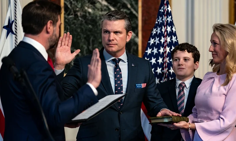 U.S. Vice President J.D. Vance (L) swears in Secretary of Defense Pete Hegseth alongside his wife Jennifer Rauchet in the Indian Treaty Room in the Eisenhower Executive Office Building on January 25, 2025 in Washington, DC. The Senate confirmed Pete Hegseth as Defense Secretary in a 51-50 vote, with Vice President J.D. Vance breaking the tie after three Republicans joined Democrats in opposition. It's only the second time in history that a vice president has broken a tie for a cabinet nominee. The first was Betsy DeVos in 2017. (Photo by Kent Nishimura/Getty Images)