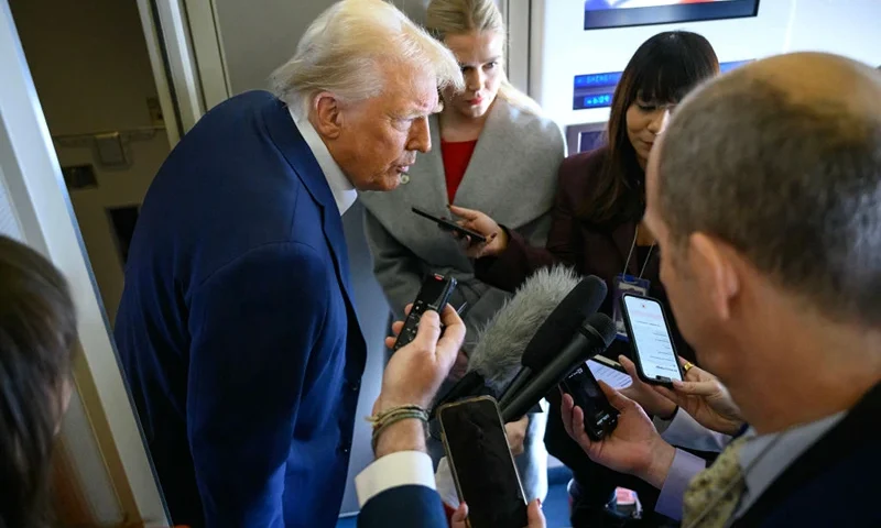 US President Donald Trump speaks with the press, alongside White House Press Secretary Karoline Leavitt (R), on board Air Force One after departing Las Vegas, Nevada, en route to Miami, Florida on January 25, 2025. After visits to disaster sites in North Carolina and California, the Vegas stop is more of a feel-good victory lap, as he lays out his plans to exclude tips from federal taxes -- an enormously popular move in a city built on the hospitality industry. (Photo by Mandel NGAN / AFP) (Photo by MANDEL NGAN/AFP via Getty Images)