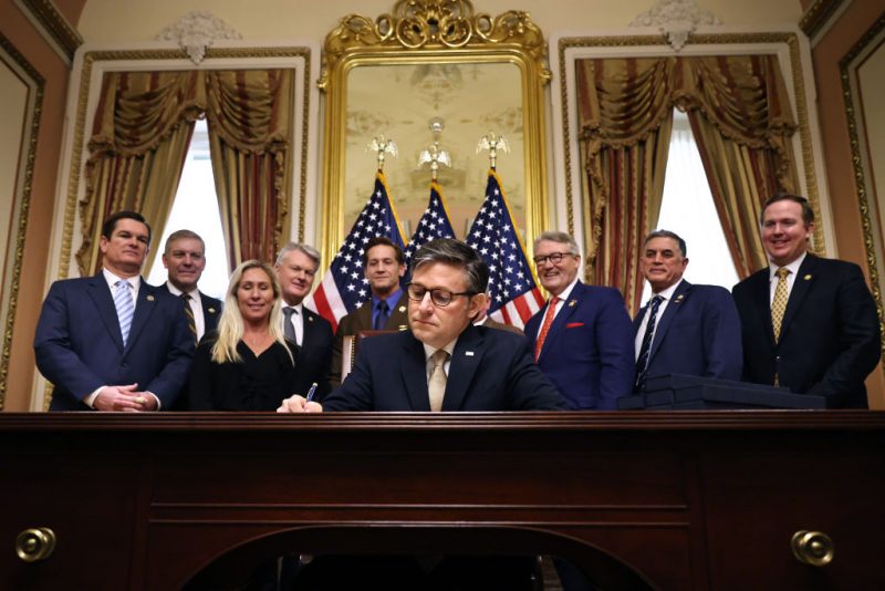 WASHINGTON, DC - JANUARY 23: Speaker of the House Mike Johnson (R-LA) signs the Laken Riley Act during an enrollment ceremony with members of the Georgia delegation in the Speaker's ceremonial office at the U.S. Capitol on January 23, 2025 in Washington, DC. Named after a young nursing student in Georgia who was murdered by a Venezuelan man, the Laken Riley Act requires the detainment of unauthorized immigrants accused of theft and violent crimes and it will be the first legislation that President Donald Trump will sign during his second term in office. (Photo by Chip Somodevilla/Getty Images)