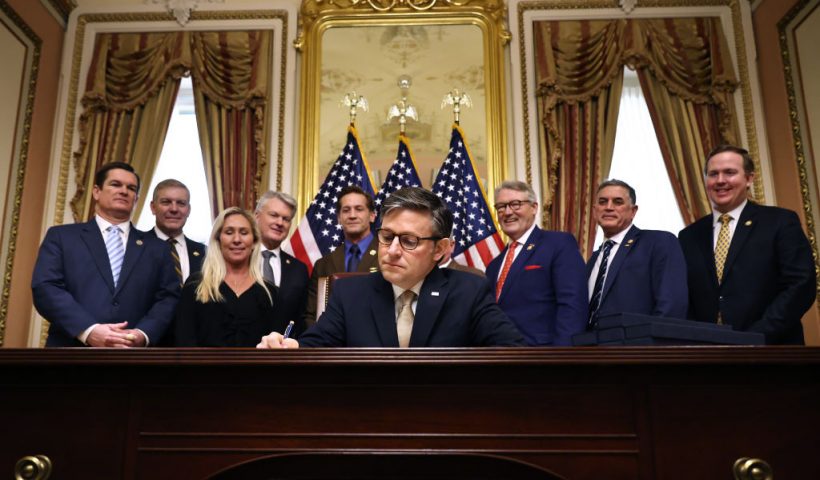 WASHINGTON, DC - JANUARY 23: Speaker of the House Mike Johnson (R-LA) signs the Laken Riley Act during an enrollment ceremony with members of the Georgia delegation in the Speaker's ceremonial office at the U.S. Capitol on January 23, 2025 in Washington, DC. Named after a young nursing student in Georgia who was murdered by a Venezuelan man, the Laken Riley Act requires the detainment of unauthorized immigrants accused of theft and violent crimes and it will be the first legislation that President Donald Trump will sign during his second term in office. (Photo by Chip Somodevilla/Getty Images)