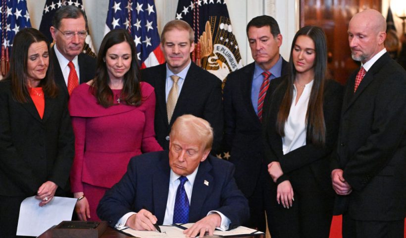US President Donald Trump signs the Laken Riley Act in the East Room of the White House in Washington, DC, January 29, 2025. The Laken Riley Act -- which mandates the detention of undocumented immigrants charged with theft-related crimes -- is named for a 22-year-old student murdered by a Venezuelan man with no papers who was wanted for shoplifting. (Photo by ROBERTO SCHMIDT / AFP) (Photo by ROBERTO SCHMIDT/AFP via Getty Images)