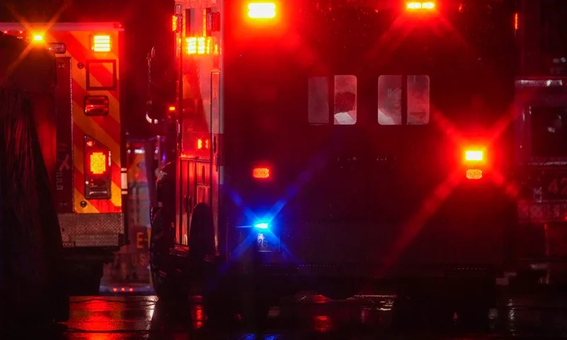 WASHINGTON, DC - JANUARY 31: Ambulances drive off as local first responders salute the flag draped bodies of service members killed in the aviation crash at a temporary emergency disaster site at Buzzards Point on January 31, 2025 in Washington, DC. An American Airlines flight from Wichita, Kansas collided with a helicopter while approaching Ronald Reagan National Airport. (Photo by Andrew Harnik/Getty Images)
