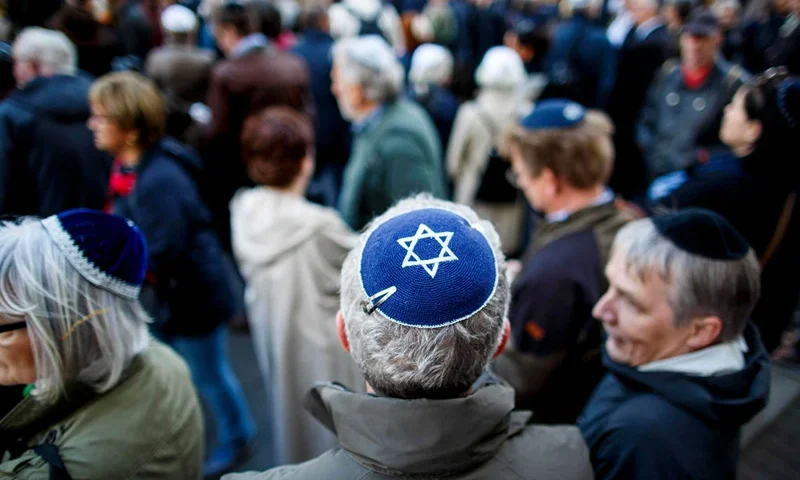 BERLIN, GERMANY - APRIL 25: Participants wearing a kippah during a "wear a kippah" gathering to protest against anti-Semitism in front of the Jewish Community House on April 25, 2018 in Berlin, Germany. The Jewish community made a public appeal for Jews and non-Jews to attend the event and wear a kippah as a show of solidarity. The effort was sparked by a recent incident in Berlin in which a Syrian Palestinian man berated and struck with his belt a man wearing a kippah. The kippah-wearer was not Jewish, but an Israeli Arab who wore the kippah curious what reaction he might receive while walking in Berlin. In 2017 Germany reportedly recorded 1453 criminal offenses related to anti-Semitism, of which 94 percent were attributed to German citizens. (Photo by Carsten Koall/Getty Images)