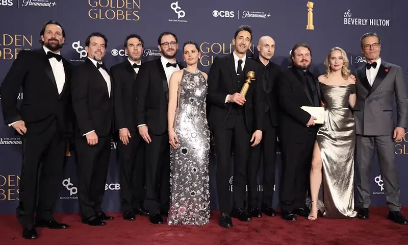 Trevor Matthews, Brian Young, Felicity Jones, Adrien Brody, winner of the Best Performance by a Male Actor in a Motion Picture - Drama award for "The Brutalist," Daniel Blumberg, Brady Corbet, Mona Fastvold, and Guy Pearce, winners of the Best Motion Picture - Drama award for "The Brutalist", pose at the 82nd Golden Globe Awards in Beverly Hills, California, U.S., January 5, 2025. REUTERS/Mario Anzuoni