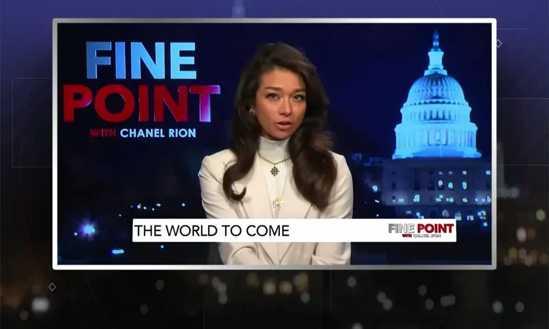 Video still of the host of Fine Point at the desk of their talk show on One America News Network.