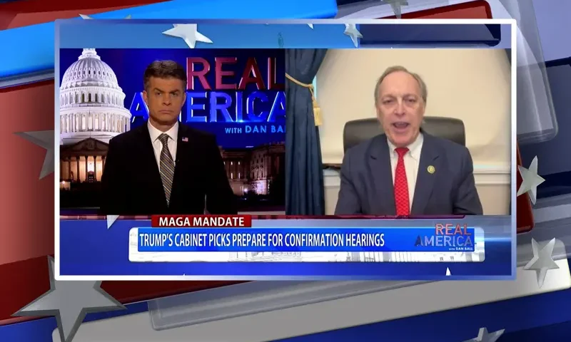 Video still from Real America on One America News Network showing a split screen of the host on the left side, and on the right side is the guest, Rep. Andy Biggs.