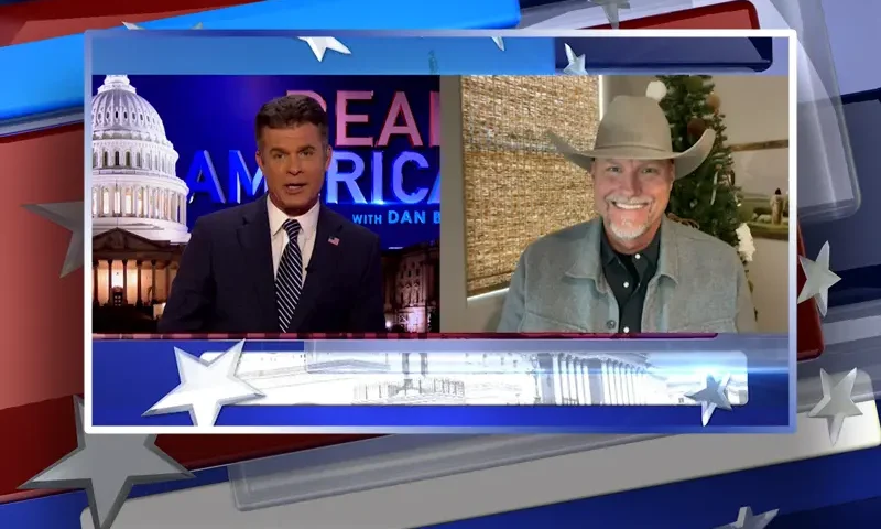 Video still from Real America on One America News Network showing a split screen of the host on the left side, and on the right side is the guest, Mark Lamb.